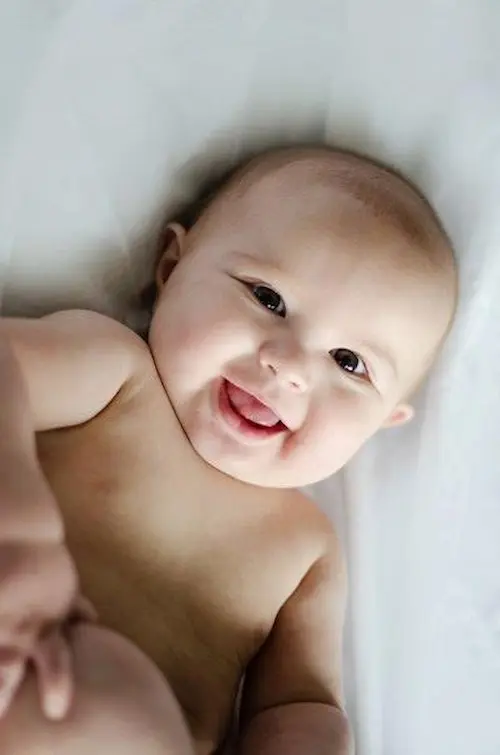 A girl with a baby on a bed