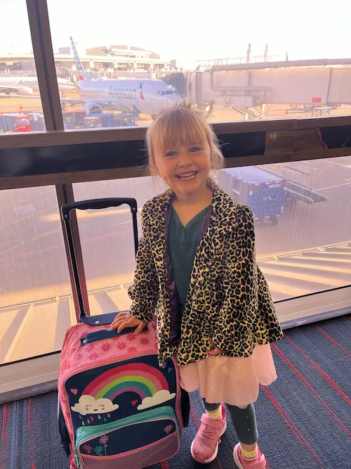 Travel nanny assisting family at vacation